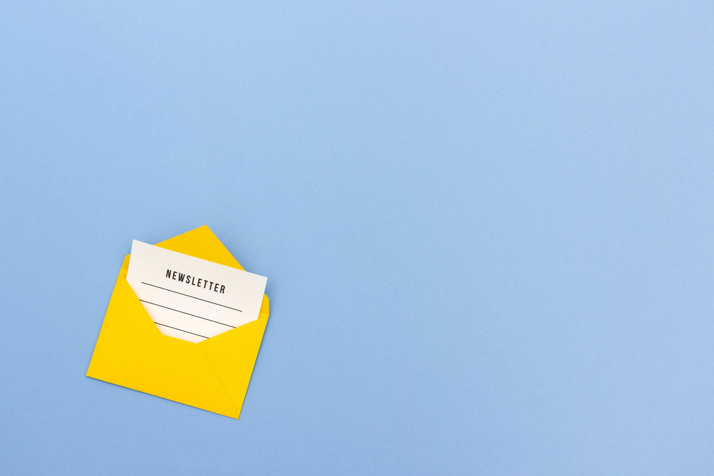 Yellow envelope with newsletter on blue background